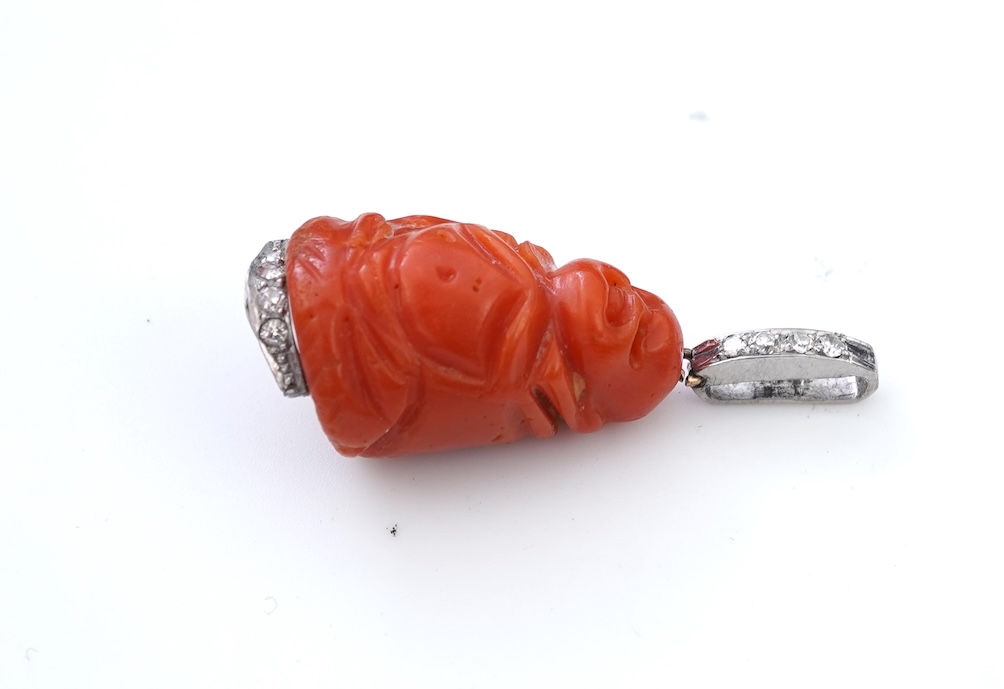 An Art Deco carved coral and diamond pendant, 1920s